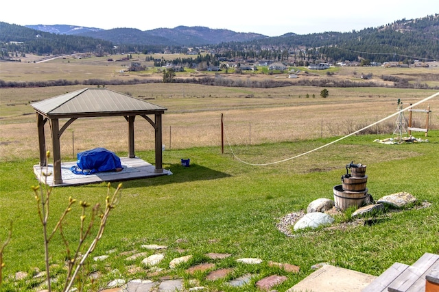 view of yard with a gazebo, a mountain view, a rural view, and fence