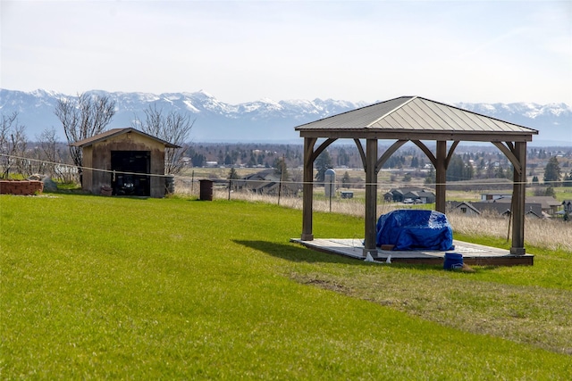 view of yard with a gazebo, a mountain view, and fence