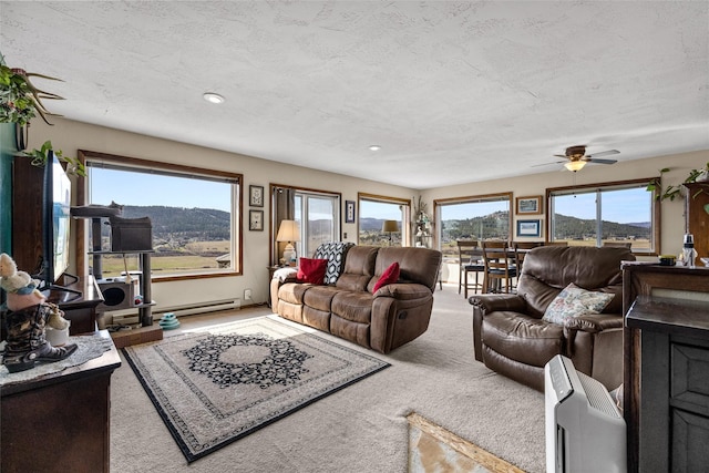 carpeted living area featuring ceiling fan, baseboard heating, recessed lighting, and a textured ceiling