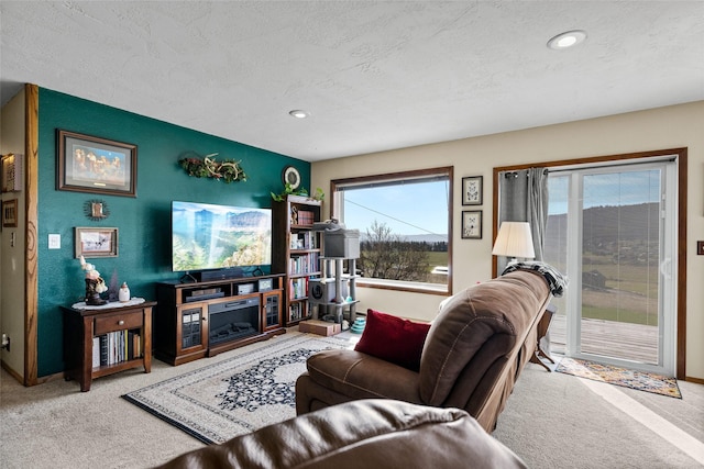 carpeted living room with recessed lighting, a textured ceiling, and baseboards