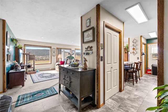 hall with plenty of natural light and a textured ceiling