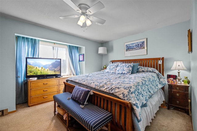 bedroom featuring light carpet and a ceiling fan