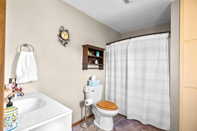 full bathroom with vanity, toilet, and curtained shower