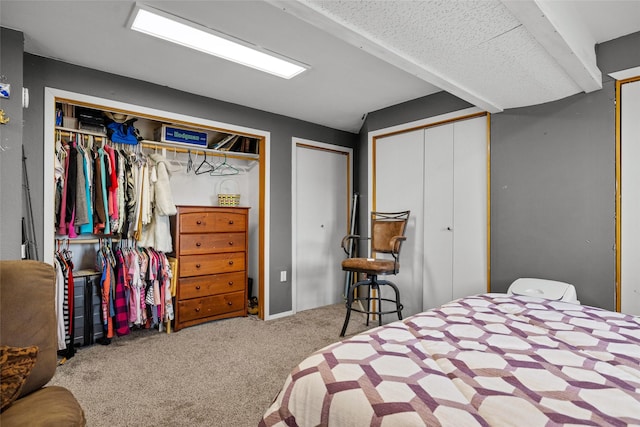 carpeted bedroom featuring multiple closets