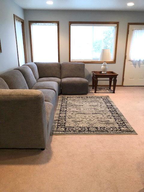 carpeted living room with recessed lighting