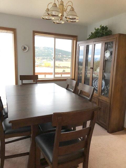 dining space featuring an inviting chandelier and light colored carpet