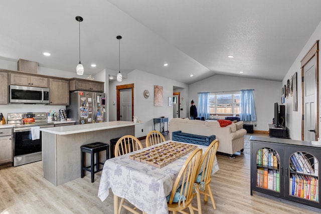 dining area featuring recessed lighting, light wood finished floors, and vaulted ceiling