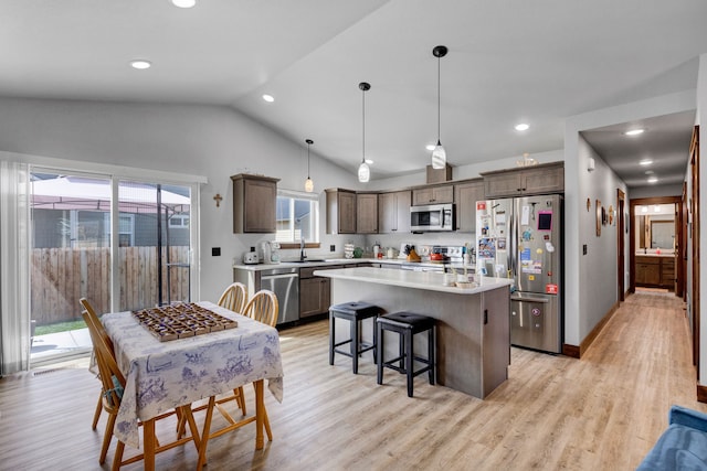 107 One Way Loop, Hamilton, MT 59840 - kitchen featuring appliances with stainless steel finishes, lofted ceiling, a center island, light countertops, and light wood-type flooring