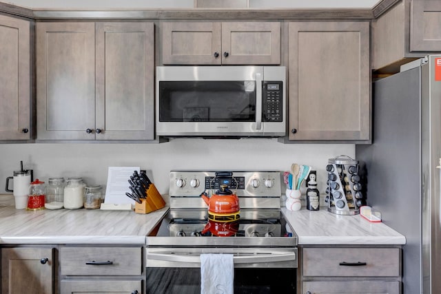 kitchen with light countertops and appliances with stainless steel finishes
