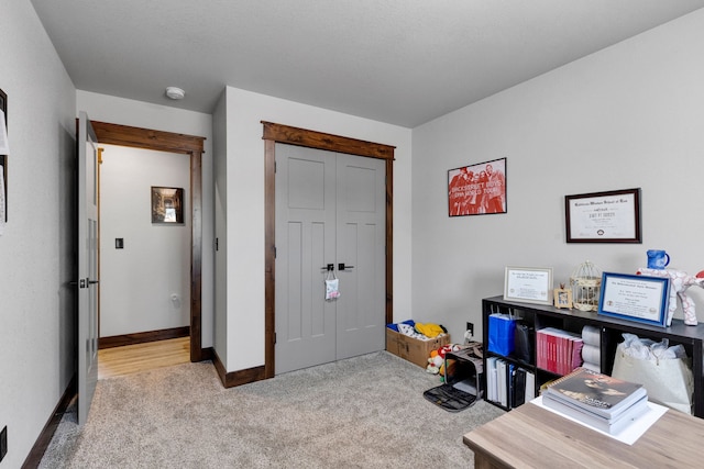 home office featuring baseboards and carpet