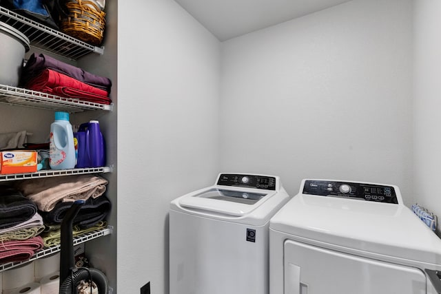 clothes washing area featuring washer and dryer and laundry area