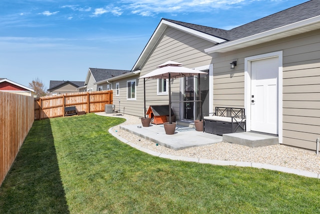 back of house featuring roof with shingles, a lawn, a patio area, central air condition unit, and a fenced backyard