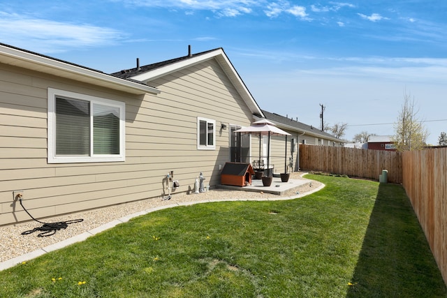 rear view of property with a fenced backyard, a patio, a gazebo, and a lawn