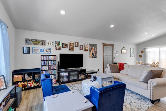 living room with recessed lighting, light wood-type flooring, and lofted ceiling