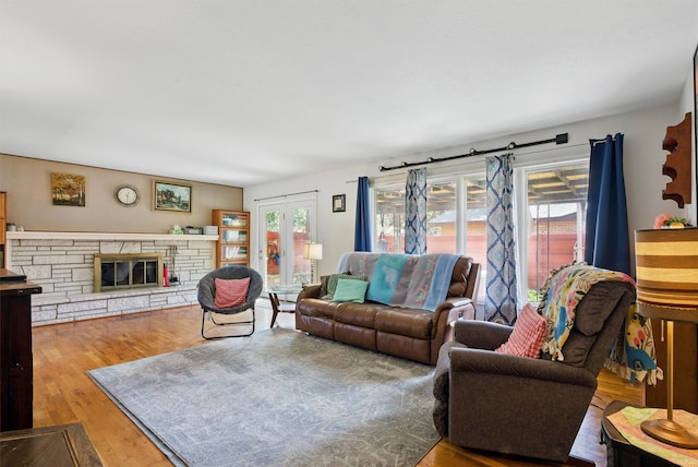 living area featuring wood finished floors and a fireplace
