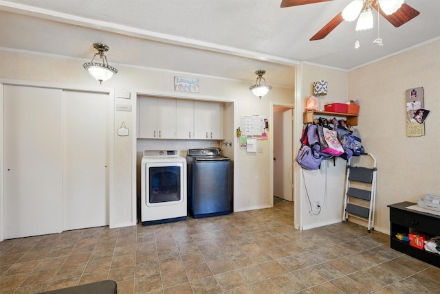 laundry room featuring ceiling fan, stone finish flooring, cabinet space, separate washer and dryer, and ornamental molding