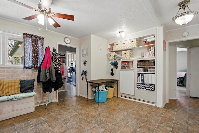 interior space featuring crown molding, ceiling fan, and a textured ceiling