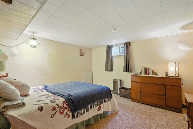 bedroom featuring radiator and light colored carpet