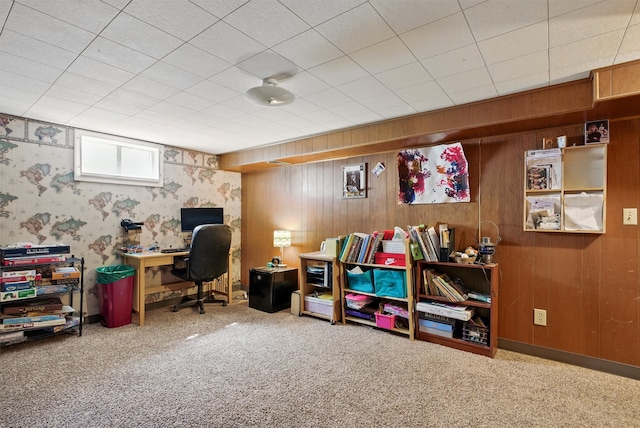 carpeted home office with wood walls