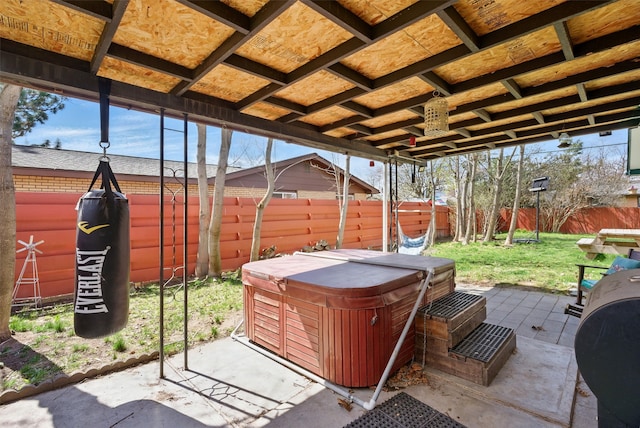 view of patio featuring a hot tub and a fenced backyard