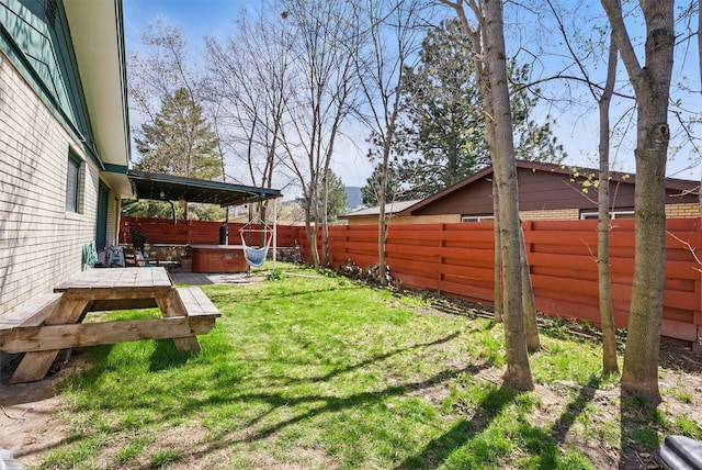 view of yard featuring a fenced backyard, a hot tub, and a deck