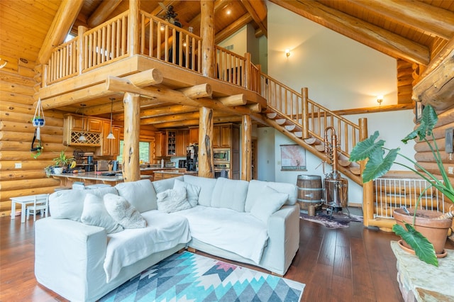 living room with stairs, high vaulted ceiling, log walls, and wood ceiling