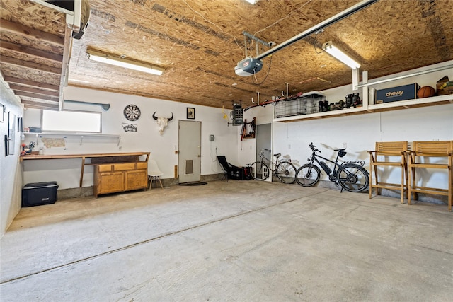 garage with a workshop area and a garage door opener