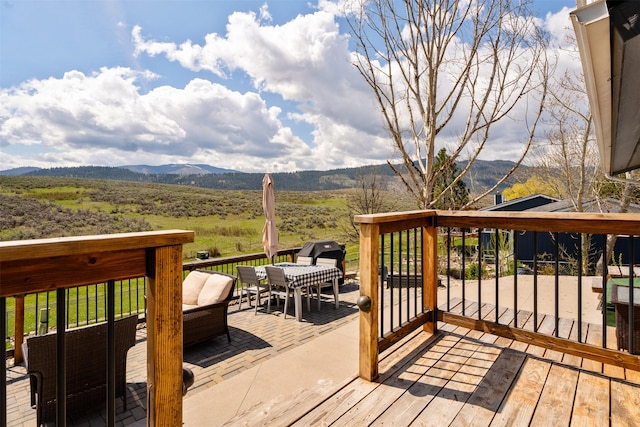 wooden deck with outdoor lounge area and a mountain view