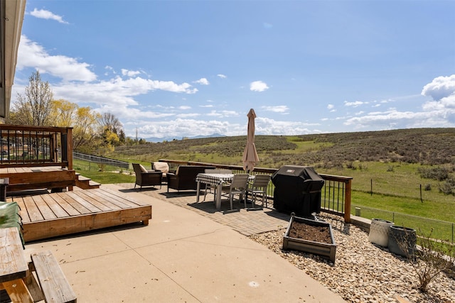 9225 Sharptail Dr, Missoula, MT 59808 - view of patio / terrace featuring a wooden deck, outdoor dining space, and area for grilling