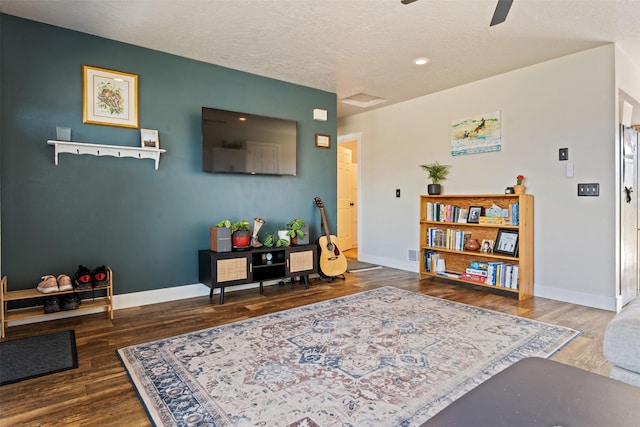 living area with baseboards, ceiling fan, recessed lighting, and wood finished floors
