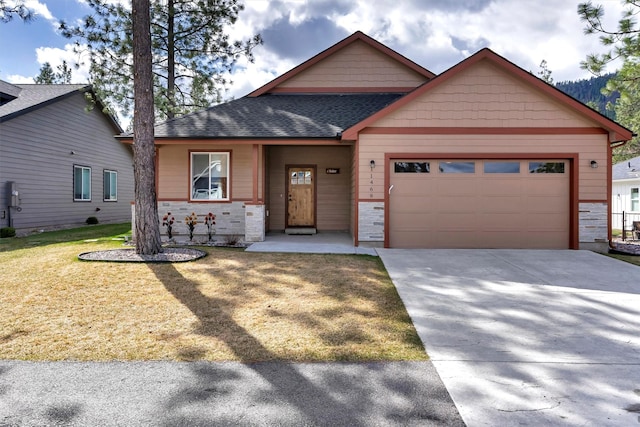 craftsman inspired home with a garage, a front lawn, stone siding, roof with shingles, and concrete driveway