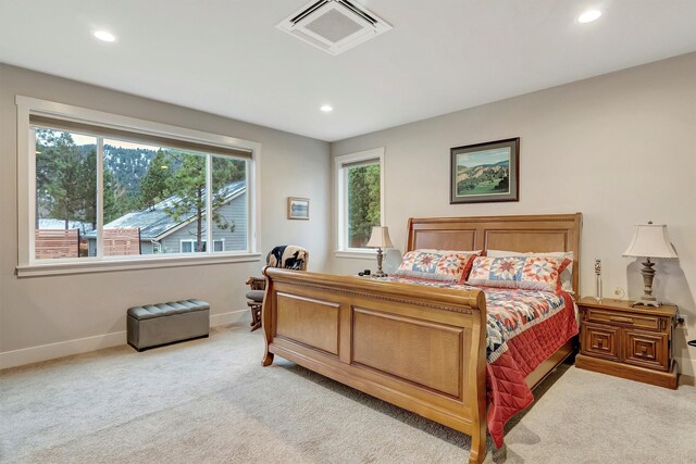 bedroom with baseboards, light colored carpet, recessed lighting, and visible vents