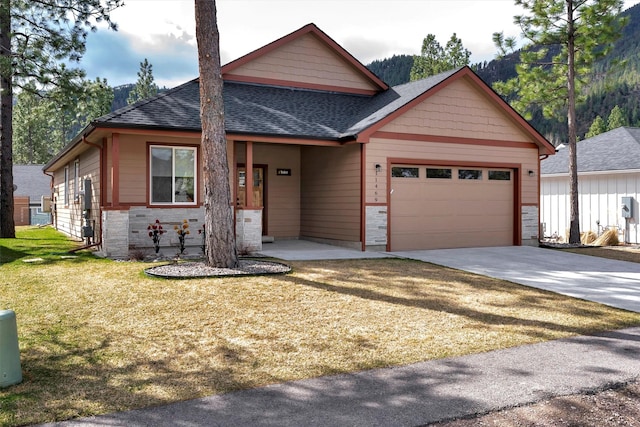 craftsman inspired home featuring stone siding, a front yard, a shingled roof, concrete driveway, and an attached garage