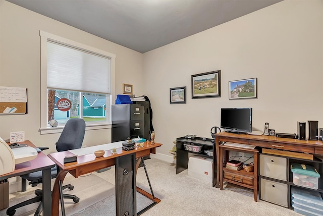carpeted office space with baseboards
