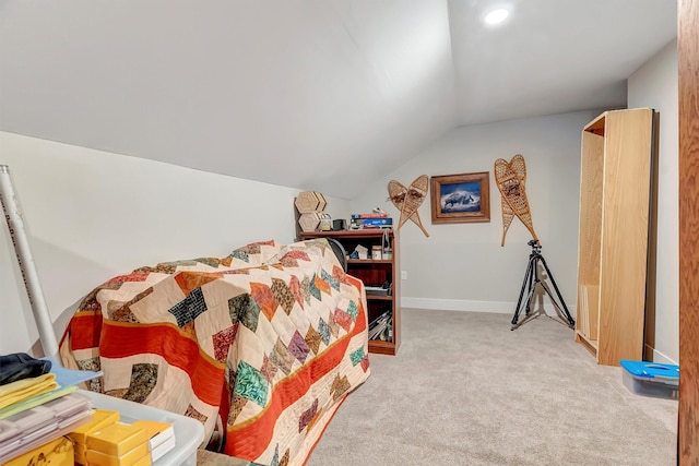 bedroom with baseboards, carpet, and lofted ceiling