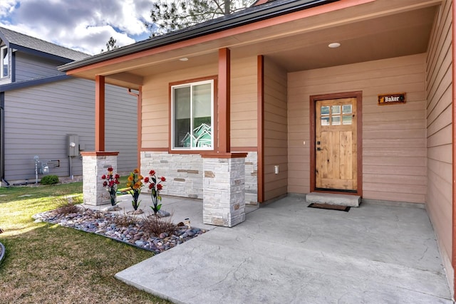 view of exterior entry featuring stone siding