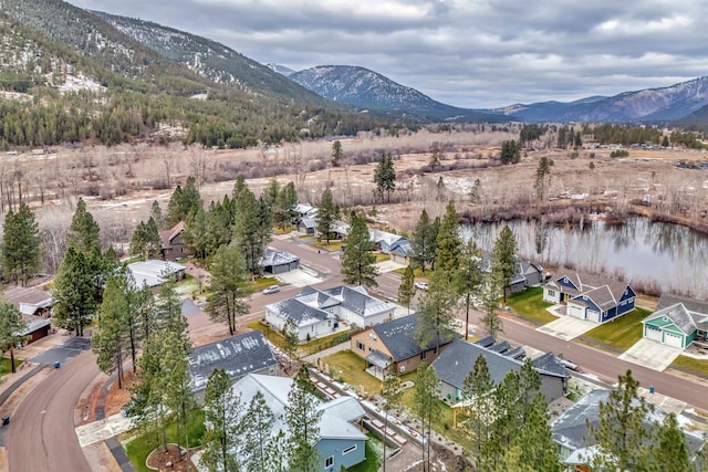 birds eye view of property with a water and mountain view and a residential view