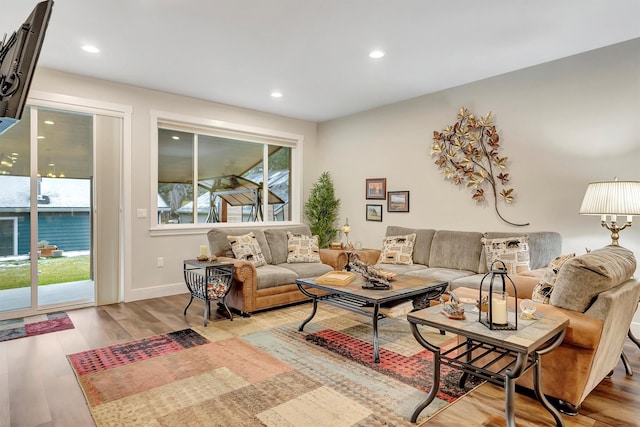 living area featuring baseboards, recessed lighting, and wood finished floors