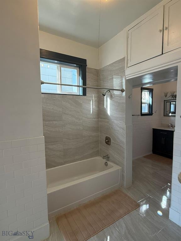 bathroom featuring vanity, tile patterned flooring, and bathtub / shower combination