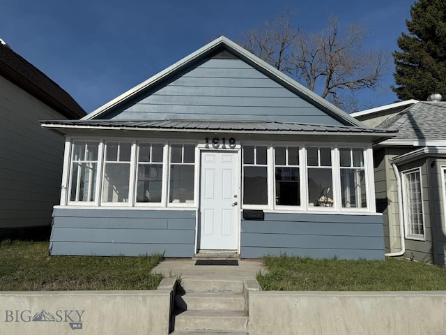 bungalow-style house featuring a sunroom