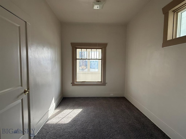 carpeted empty room with baseboards