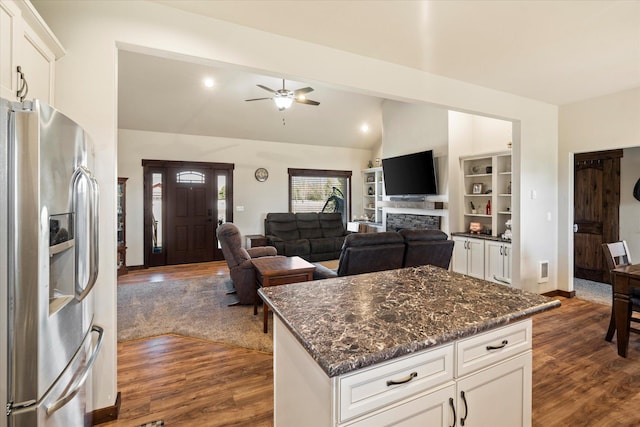 kitchen with white cabinets, ceiling fan, stainless steel fridge with ice dispenser, dark stone countertops, and dark wood-style floors