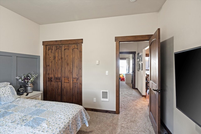 bedroom with carpet floors, baseboards, and visible vents