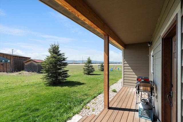 wooden deck featuring a yard