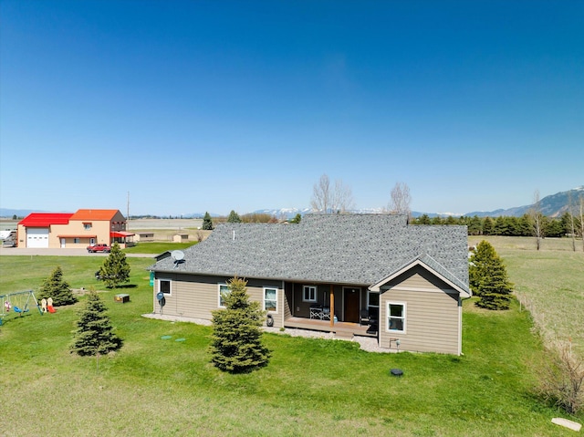 view of front facade with a mountain view and a front lawn