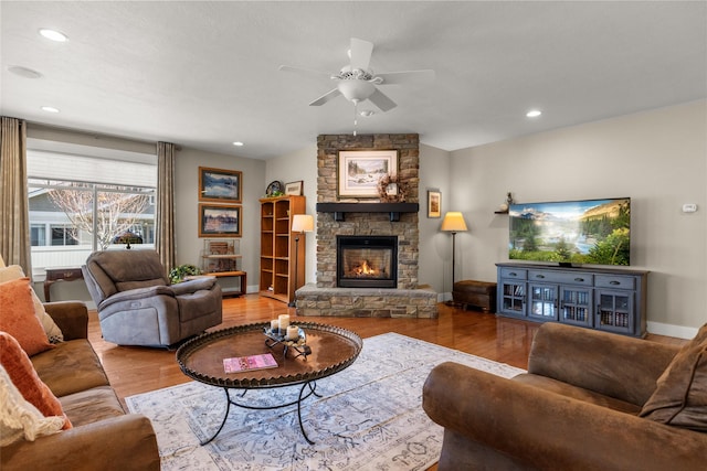 154 Taelor Rd, Kalispell, MT 59901 - living room featuring wood finished floors, a ceiling fan, a fireplace, and recessed lighting