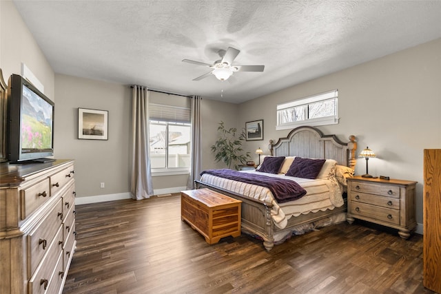 bedroom with baseboards, a ceiling fan, a textured ceiling, and dark wood-style floors