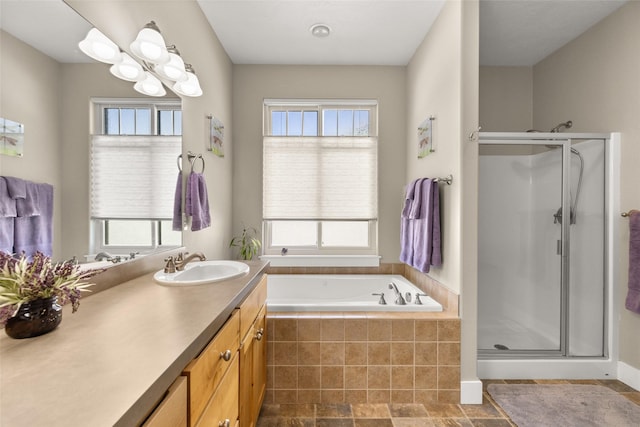 bathroom with a healthy amount of sunlight, vanity, and a stall shower