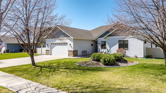 view of front of house featuring driveway, a garage, fence, a front lawn, and stone siding