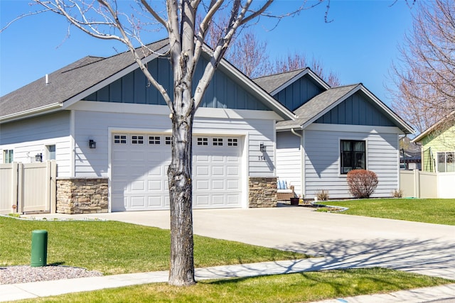 154 Taelor Rd, Kalispell, MT 59901 - craftsman-style house featuring board and batten siding, an attached garage, driveway, stone siding, and a shingled roof